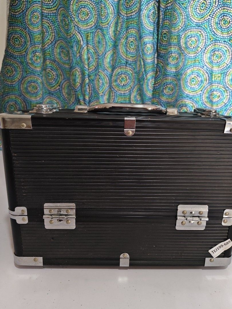 Black Aluminum Makeup Case with Trays (Category: Makeup) located in Manila. Submitted by babz30261 (Listing ID 1406027264, Image 3). Description: - Black aluminum makeup case - Sturdy handle and secure latches - Multiple pull-out trays for organized storage - Reinforced corners for durability - Ideal for makeup storage and travel.