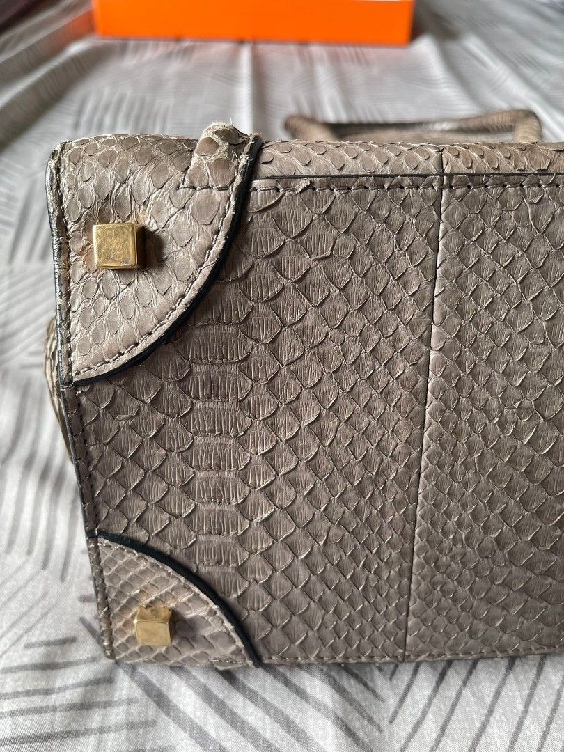 Celine Python Leather Handbag (Category: Bags & Wallets) located in Singapore. Submitted by drewtcg (Listing ID 1406021411, Image 3). Description: - Authentic Celine handbag - Genuine python leather - Top handle design - Zip closure - Interior with branded leather tag - Made in Italy - Stylish and luxurious Condition - Used well.