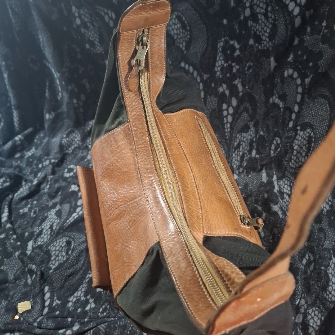 Il Bisonte Leather and Canvass Combi Shoulder Bag (Category: Shoulder Bags) located in Manila. Submitted by jjprelovedcollections2 (Listing ID 1406066362, Image 3). Description: - Authentic Il Bisonte shoulder bag - Brown leather and Black Canvass - Front pocket with buckle closure - Zippered main compartment - Adjustable shoulder strap - Needs cleaning both leather and canvass (repainted ng black ung canvass) mas ok na tignan vs sa post..