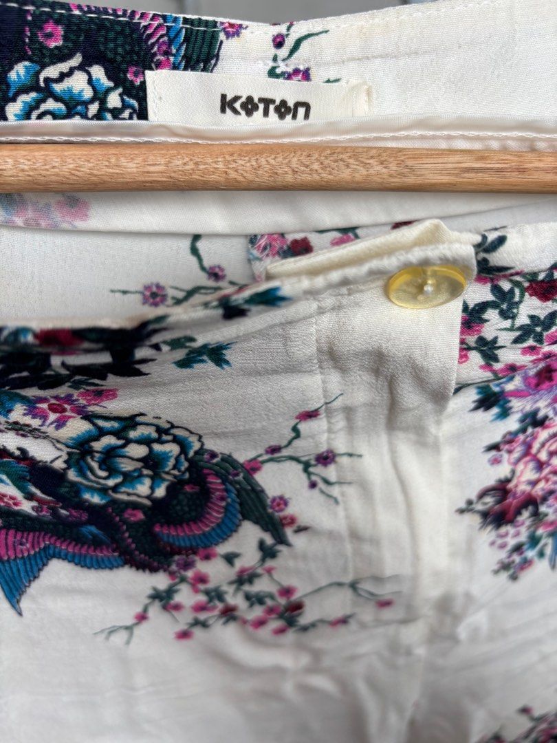 Koton Floral Print Pants (Category: Other Bottoms) located in Marikina City. Submitted by decluttering__E (Listing ID 1405914468, Image 2). Description: - Koton floral print pants - Size: EUR 36, UK 10 - Features a white base with vibrant floral pattern - Button closure - Pockets - Condition: Some visible stains.
