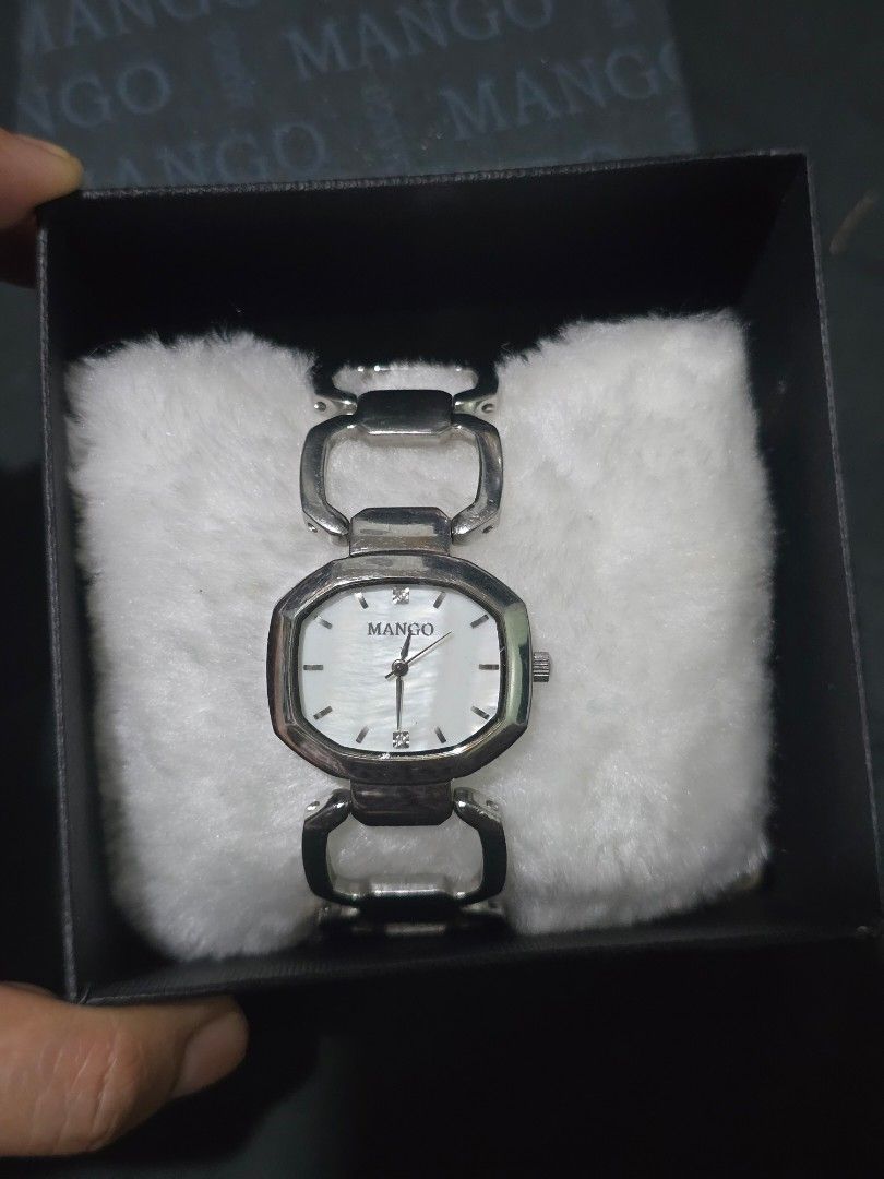 Mango Silver Watch (Category: Women's Watches) located in Manila. Submitted by muliph (Listing ID 1405918444, Image 3). Description: Elegant Mango watch with a silver band and a unique square face. The watch comes with its original box. The watch face has a mother-of-pearl effect. The watch is water resistant. The band has a distinctive design with open links..