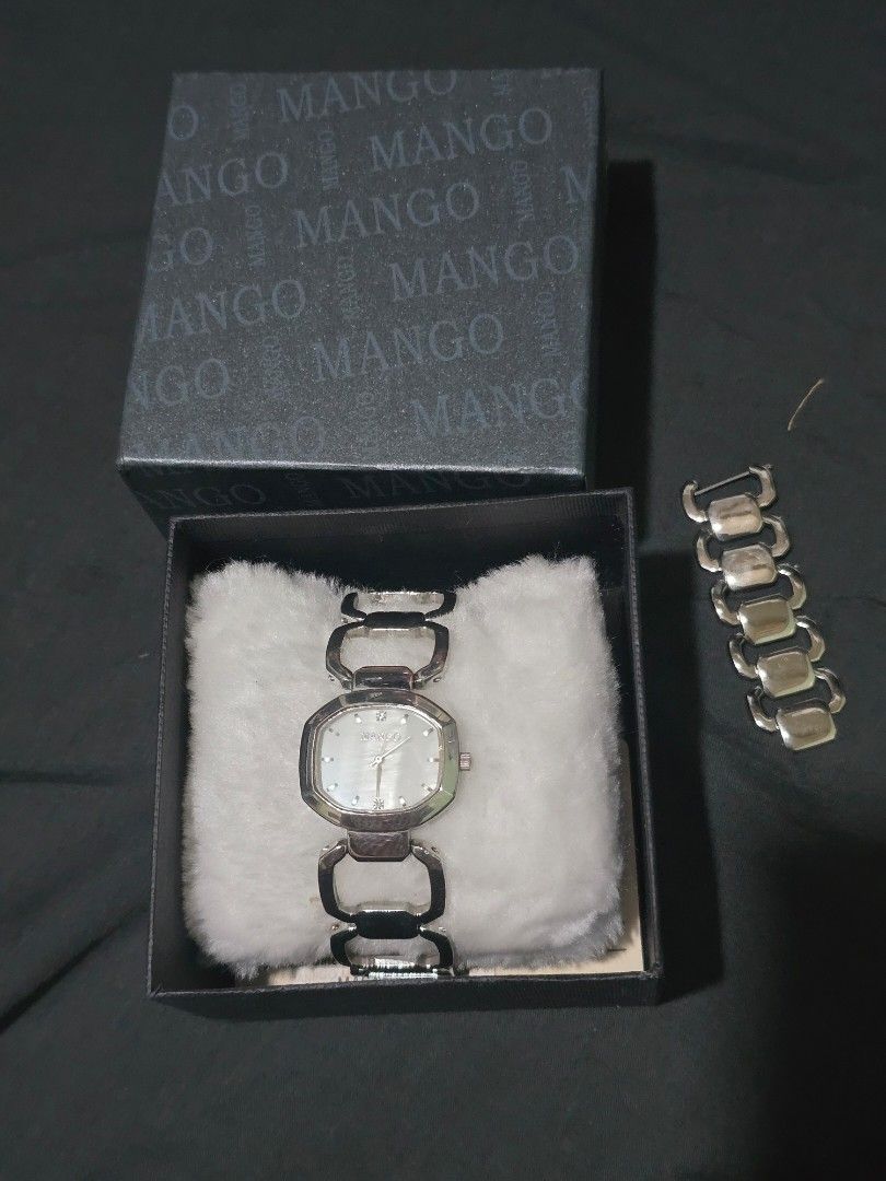Mango Silver Watch (Category: Women's Watches) located in Manila. Submitted by muliph (Listing ID 1405918444, Image 2). Description: Elegant Mango watch with a silver band and a unique square face. The watch comes with its original box. The watch face has a mother-of-pearl effect. The watch is water resistant. The band has a distinctive design with open links..
