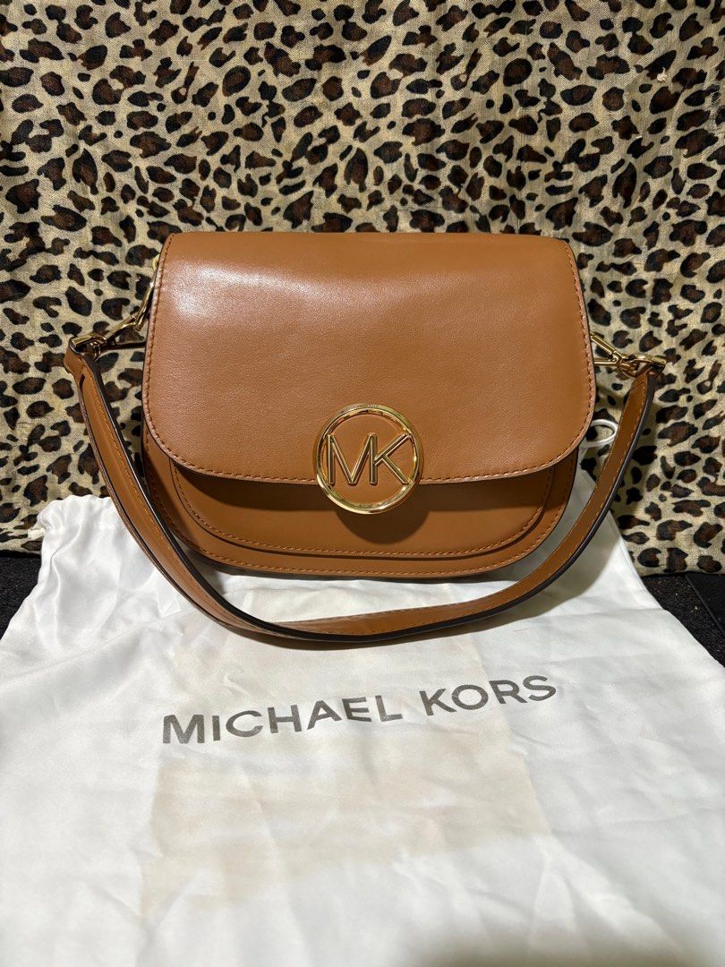 Michael Kors- Lillie Acorn Medium Saddle Bag (Category: Luxury Bags & Wallets) located in Santa Cruz, Pampanga. Submitted by pauleennuquivalencia4164 (Listing ID 1406009843, Image 1). Description: Acorn smooth leather Gold-tone hardware, a leather and metal strap and detachable and adjustable shoulder strap Multiple interior compartments.