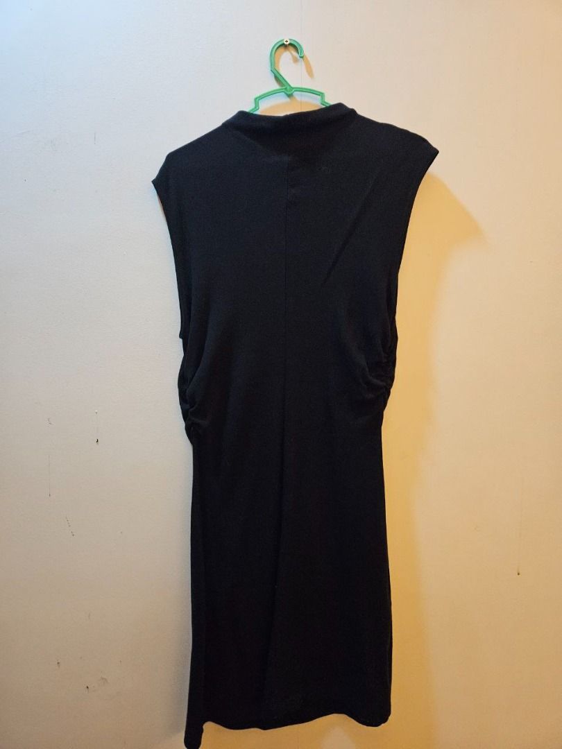 MNG Black Sleeveless Dress (Category: Dresses) located in Cebu City. Submitted by theclosetsaleph (Listing ID 1406031004, Image 2). Description: - MNG black sleeveless dress - Size: M - Features a mock neck - Ruched detailing on the sides - Knee-length - Suitable for various occasions.
