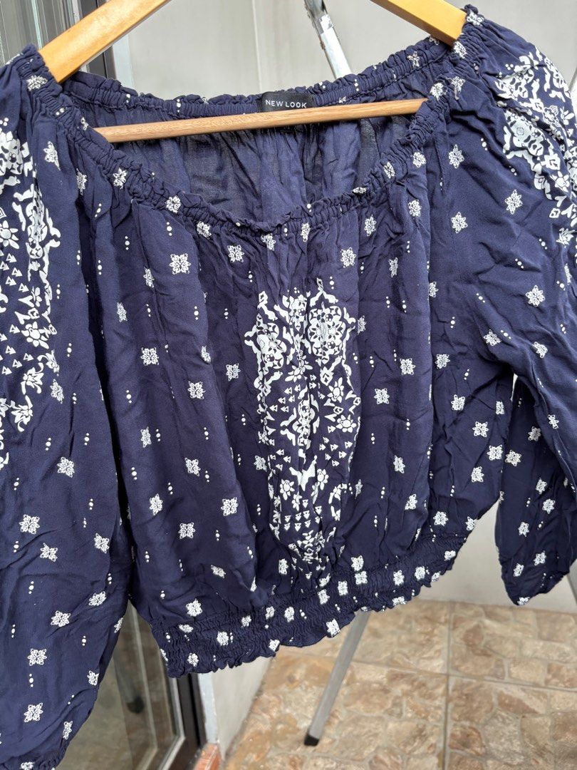 New Look Off-Shoulder Top (Category: Blouses) located in Marikina City. Submitted by decluttering__E (Listing ID 1405914547, Image 3). Description: - New Look off-shoulder top - Navy blue with white floral pattern - Size M - Long sleeves - Elasticated neckline and hem.