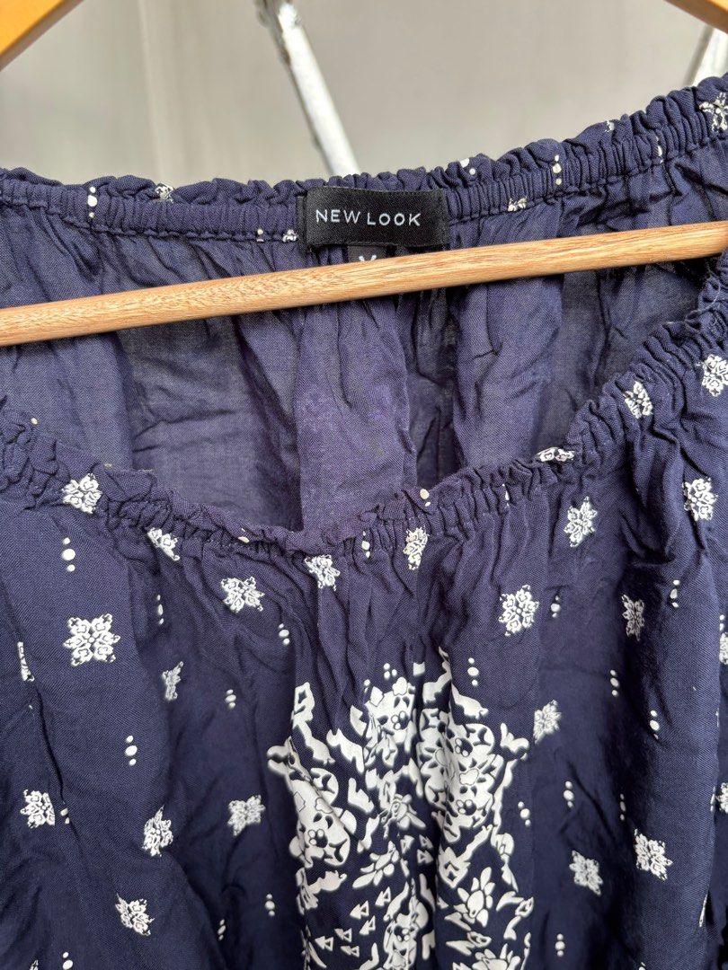 New Look Off-Shoulder Top (Category: Blouses) located in Marikina City. Submitted by decluttering__E (Listing ID 1405914547, Image 2). Description: - New Look off-shoulder top - Navy blue with white floral pattern - Size M - Long sleeves - Elasticated neckline and hem.