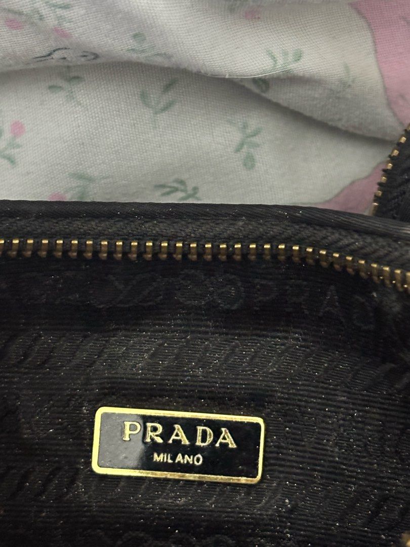 Prada Black Shoulder Bag with Coin Purse (Category: Luxury Bags & Wallets) located in Dasmarinas. Submitted by floweringinyou (Listing ID 1405995213, Image 2). Description: - Thrifted Prada shoulder bag - Classic black color - Elegant gold chain strap and hardware - Includes a matching coin purse - Features a small pouch attached to the strap - Secure zipper closure - Prada Milano interior label - Bought in a Vintage Bag Shop in Dubai.