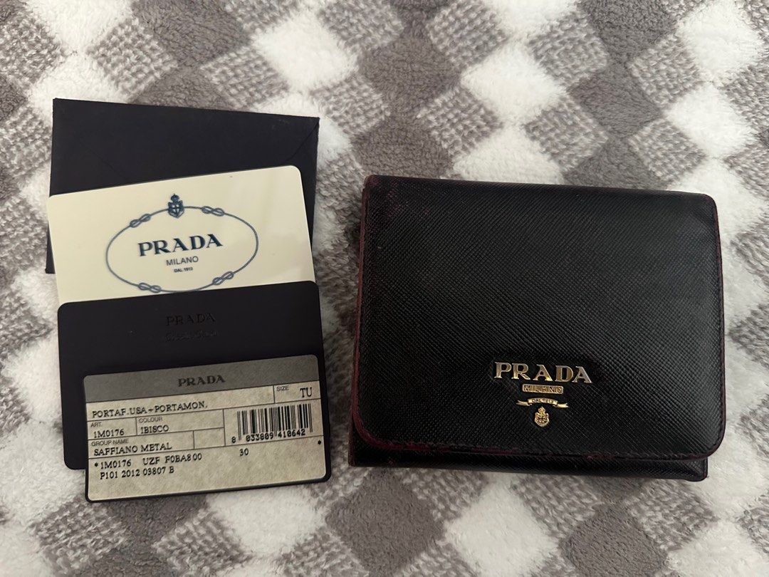 Prada Saffiano Metal Tri-Fold Wallet (Category: Luxury Bags & Wallets) located in Marilao. Submitted by kikaypena (Listing ID 1405970831, Image 1). Description: - Authentic Prada tri-fold wallet - Black Saffiano leather - Includes original box, authenticity cards, and product tag - Coin compartment - Multiple card slots - Prada logo visible - Well-maintained -Recolored.