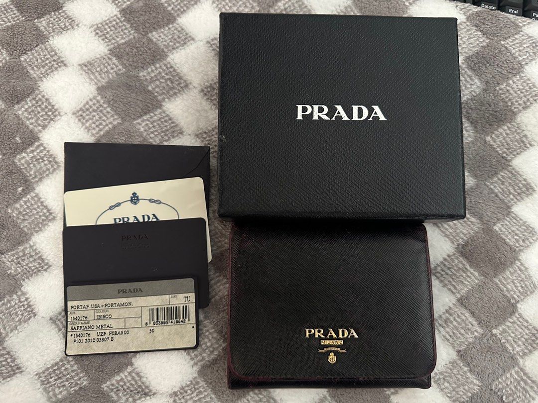 Prada Saffiano Metal Tri-Fold Wallet (Category: Luxury Bags & Wallets) located in Marilao. Submitted by kikaypena (Listing ID 1405970831, Image 2). Description: - Authentic Prada tri-fold wallet - Black Saffiano leather - Includes original box, authenticity cards, and product tag - Coin compartment - Multiple card slots - Prada logo visible - Well-maintained -Recolored.