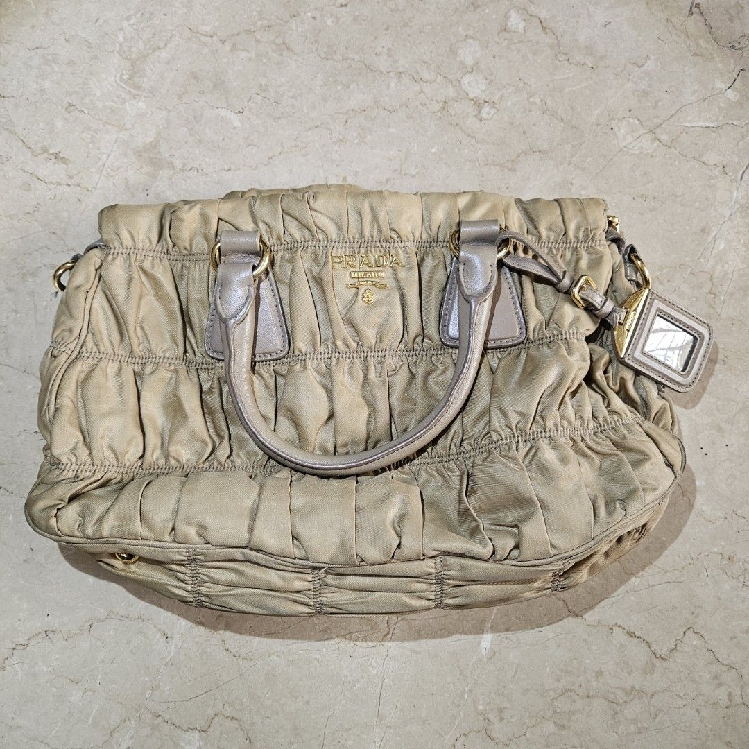 Prada Tessuto Gaufre Camello Handbag (Category: Luxury Bags & Wallets) located in Quezon City. Submitted by killerkevvv (Listing ID 1405933952, Image 1). Description: Kindly check photos for inclusions - Authentic Prada handbag - Beige color - Top handle and detachable shoulder strap - Interior zippered pocket - Includes authenticity card - Textured fabric exterior.