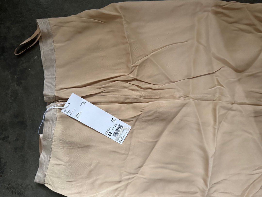 Uniqlo U Beige Skirt (Category: Skirts) located in Palayan City. Submitted by decluttering_2018 (Listing ID 1406097666, Image 1). Description: - Uniqlo U skirt - Color: Beige - Size: 64 - Condition: New with tag - Features: Zipper closure - Design: Simple and elegant - Fabric: Likely lightweight and smooth - Perfect for various occasions WOMEN’S Satin Midi Skirt 31 Beige 100% Rayon Waist 64cm Hip 91cm.