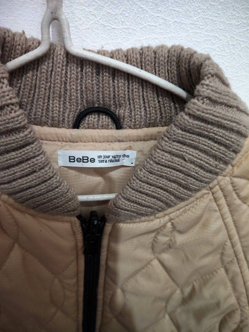 Unisex BeBe Quilted Jacket natanggal lang tag (Category: Babies & Kids Fashion) located in Victoria. Submitted by reignf027 (Listing ID 1405926811, Image 2). Description: - Brand: BeBe - Style: Kids' quilted jacket - Color: Light tan - Features: Ribbed collar and cuffs, full-length zipper closure.
