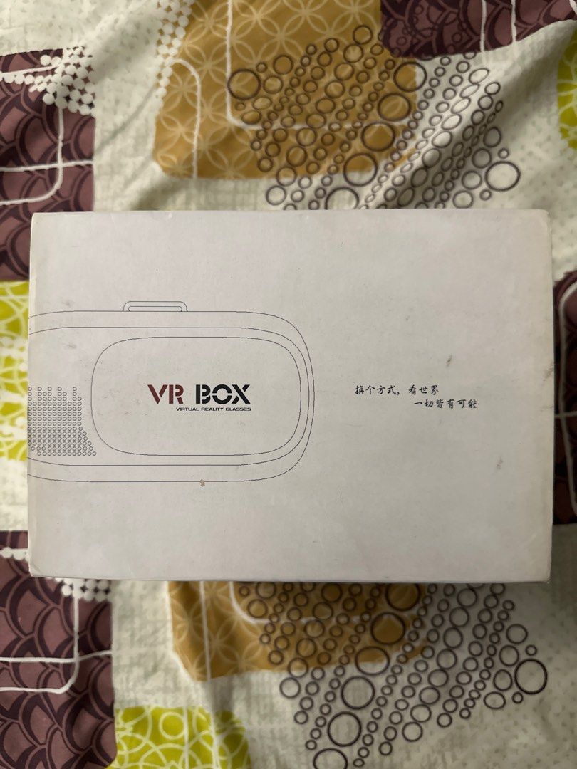 VR Box Virtual Reality Glasses (Category: Virtual Reality) located in Quezon City. Submitted by ladc1681804 (Listing ID 1406083909, Image 3). Description: - VR Box virtual reality glasses - Includes remote control - Comes with the original box - Headset color: White and black - Adjustable straps for a comfortable fit - Remote control with multiple buttons - Box features Chinese characters.