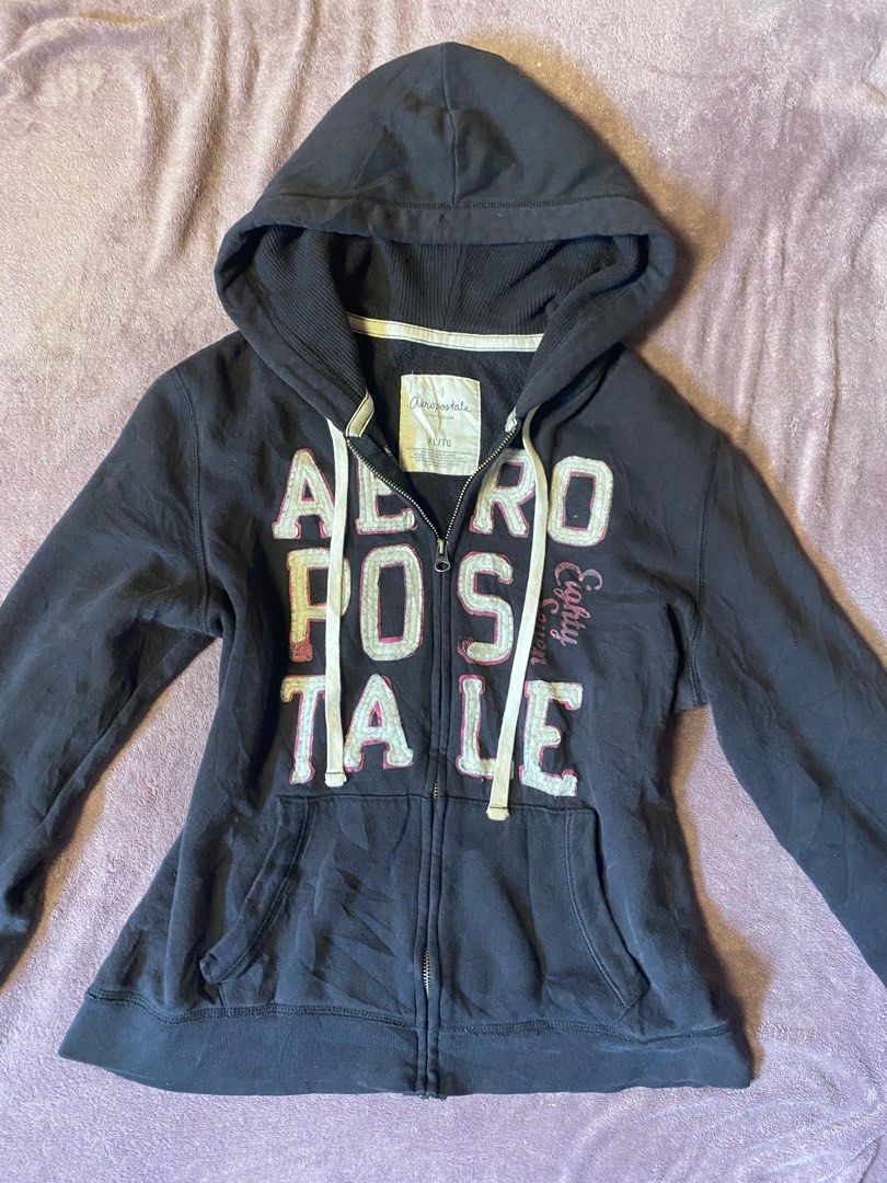 Aéropostale Zip-Up Hoodie (Category: Coats, Jackets and Outerwear) located in Zamboanga. Submitted by timeless_chi (Listing ID 1406124918, Image 1). Description: - Aéropostale zip-up hoodie - Color: Navy blue - Size: XS - Features: Hood, front pockets, full zip closure - Design: Aéropostale logo with white and pink accents - Material: Cotton blend - Sleeves: Long sleeves.