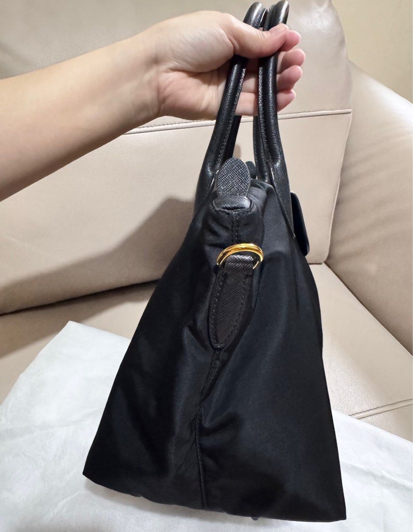 Authentic PRADA Bag ❗️❗️❗️ (Category: Luxury Bags & Wallets) located in Marikina City. Submitted by barelyshop (Listing ID 1406181476, Image 3). Description: Bag Name: Tessuto Borsa A Mano❗️ Brand: PRADA Material: Black smooth nylon Saffiano leather trim. Features: Top zip close flap snap over zipper detachable shoulder strap, with 19" drop dual handle with a 5.5 drop raised PRADA plaque zip close golden hardware and with interior zip pocket Prad