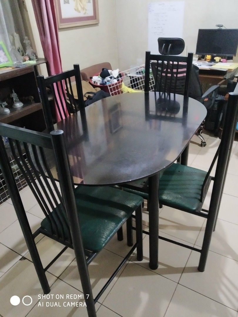 Black Dining Table with 4 Chairs (Category: Tables & Sets) located in Manila. Submitted by cyj08 (Listing ID 1406245938, Image 2). Description: - Black oval wooden dining table - Four chairs included - Chairs have green seat cushions - Chairs have black metal frames - Complete dining set - Well Used - Still Negotiable!!.