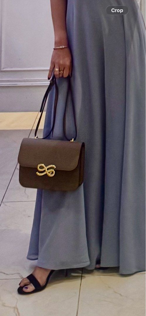 Brown Shoulder Bag with Gold Detail (Category: Shoulder Bags) located in Pasig City. Submitted by switbabyneth03 (Listing ID 1406218905, Image 1). Description: - Brown shoulder bag - Gold-colored clasp - Top handle and detachable shoulder strap - Smooth material (possibly leather) - Stylish design - Suitable for formal occasions Adjustable strap.