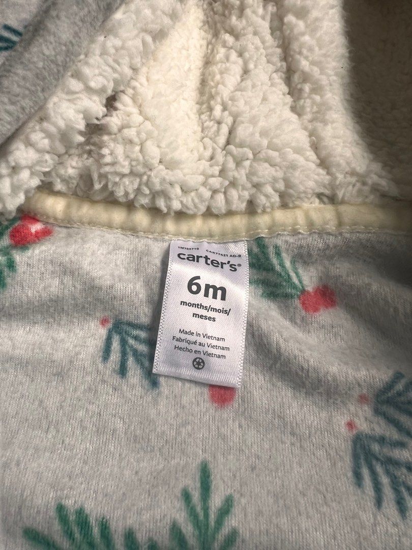 Carter's 6M Baby Onesie (Category: Babies & Kids Fashion) located in Paranaque City. Submitted by allabautstuff (Listing ID 1406143292, Image 2). Description: - Carter's onesie for 6-month-old babies. - Features a gray base with a festive leaf and berry pattern. - Includes a soft, white-lined hood. - Designed with a full-length zipper for easy dressing. - Made in Vietnam..