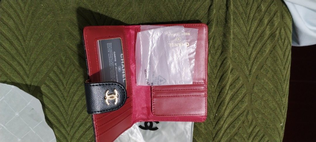 Chanel passport holder (Category: Luxury Bags & Wallets) located in Cavite. Submitted by camiya (Listing ID 1406106667, Image 2). Description: - Black chanel passport holder - Gold-tone CC logo - Red interior with card slots - Snap closure This item is onhand interested buyer you may msg us .