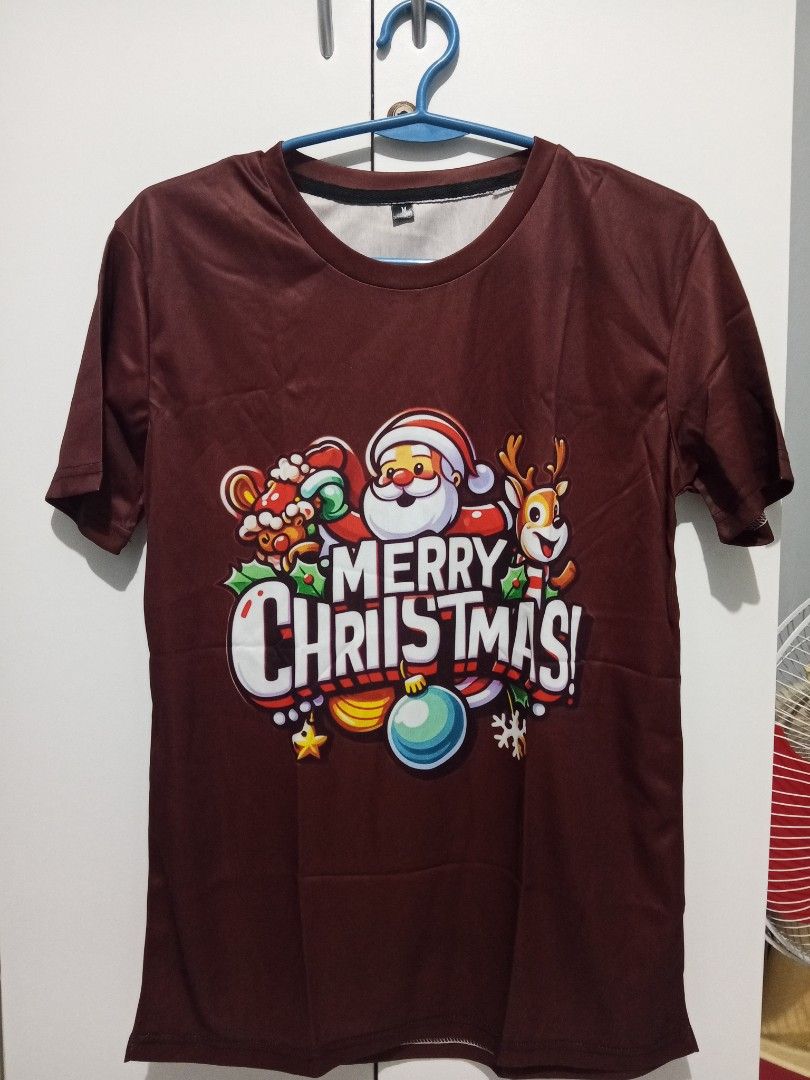 Christmas T-shirt - Size M (Category: Tshirts & Polo Shirts ) located in Santa Rosa. Submitted by briella1209 (Listing ID 1406113431, Image 3). Description: - Brown Christmas-themed t-shirt - Size: Medium (M) - Design: Santa Claus, reindeer, and "Merry Christmas!" graphic - Style: Round neck, short sleeves.