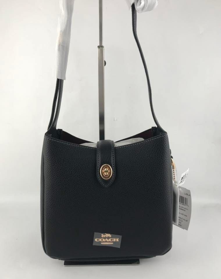 Coach Black Leather Shoulder Bag (Category: Luxury Bags & Wallets) located in Makati City. Submitted by myleen0411 (Listing ID 1406098873, Image 1). Description: - Black leather Coach shoulder bag - Top handle - Magnetic snap closure - Red interior lining - Interior zippered pocket - Gold-tone Coach logo - Includes Coach tag.