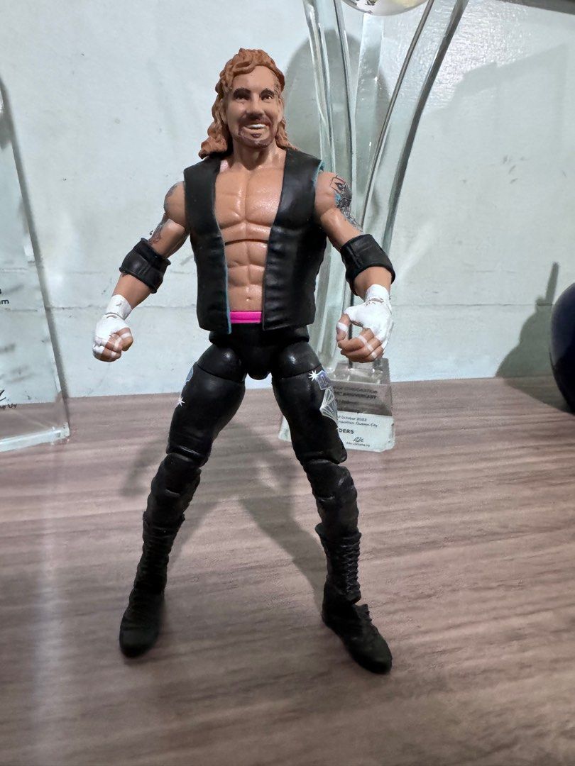 DDP Diamond Dallas Page Action Figure (Category: Action & Battle Toys) located in Quezon City. Submitted by princesspatsy100 (Listing ID 1406232616, Image 1). Description: - Diamond Dallas Page (DDP) action figure. - Features DDP in black vest and pants. - Detailed tattoos on arms. - Includes DDP logo on the back. - Collectible item for wrestling fans. - Posed in a standing position..