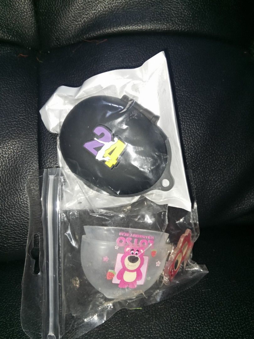 Earphone Case - Kobe Bryant & Lotso (Category: Portable Audio Accessories) located in Santa Rosa. Submitted by briella1209 (Listing ID 1406113299, Image 2). Description: - Earphone cases for sale. - Designs: - Kobe Bryant #24 (black case with purple and yellow accents) - Lotso from Toy Story (clear case with pink Lotso design) - Material: Silicone - Condition: Brand new, in original packaging..