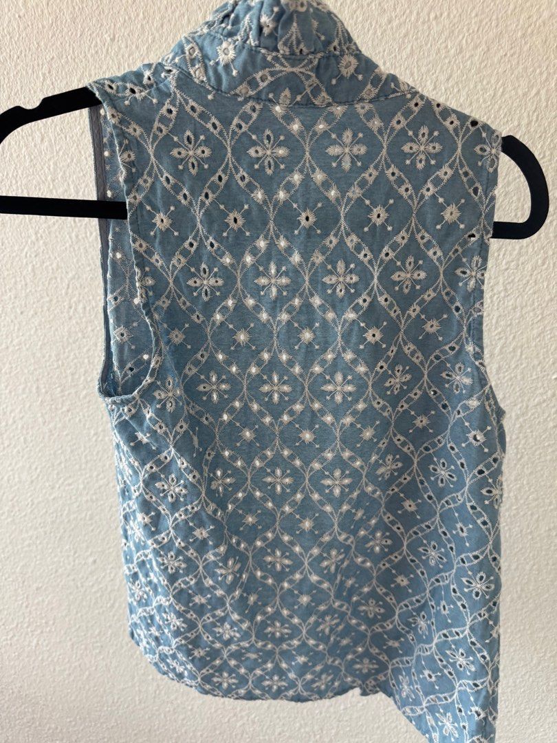 Embroidered Sleeveless Top (Category: Sleeveless) located in San Juan City. Submitted by baudeclutter (Listing ID 1406226559, Image 2). Description: - Sleeveless top in light blue. - Delicate white embroidery. - High, ruffled collar. - Button-down front. - Detailed floral pattern on the back. - Perfect for a casual, chic look..