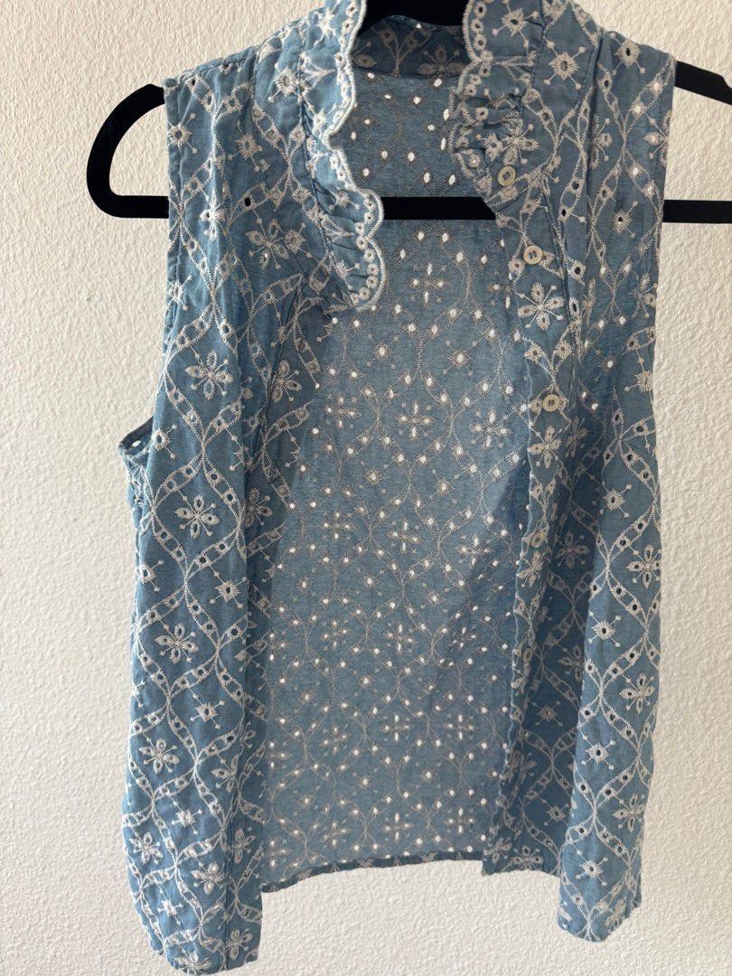 Embroidered Sleeveless Top (Category: Sleeveless) located in San Juan City. Submitted by baudeclutter (Listing ID 1406226559, Image 1). Description: - Sleeveless top in light blue. - Delicate white embroidery. - High, ruffled collar. - Button-down front. - Detailed floral pattern on the back. - Perfect for a casual, chic look..