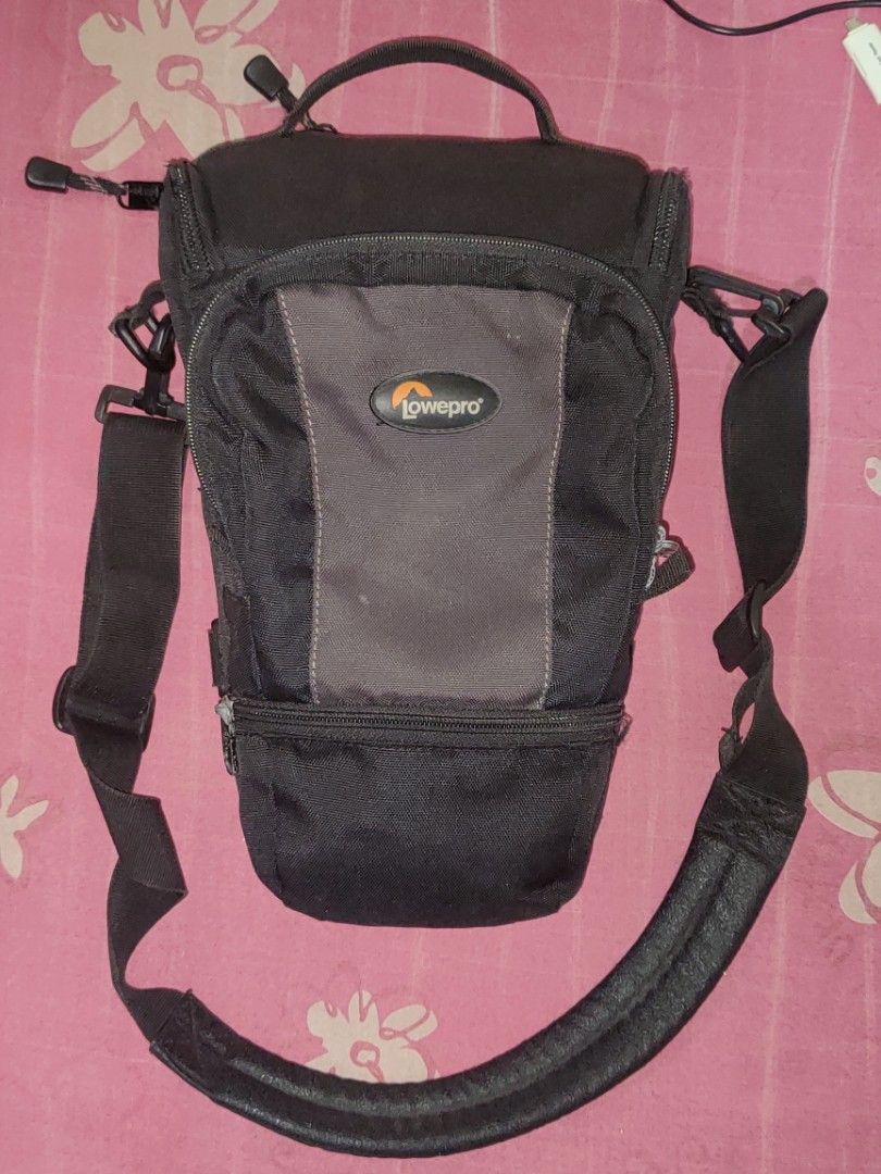 Lowepro TLZ Pro AW Camera Bag (Category: Camera Bags & Carriers) located in Calamba. Submitted by mrbustamante223 (Listing ID 1406240596, Image 3). Description: - Lowepro TLZ Pro AW camera bag - Black color - Includes shoulder strap - Multiple compartments for storage - Designed for camera and accessories - Mesh back panel for breathability - Features multiple attachment points - Lowepro logo present.