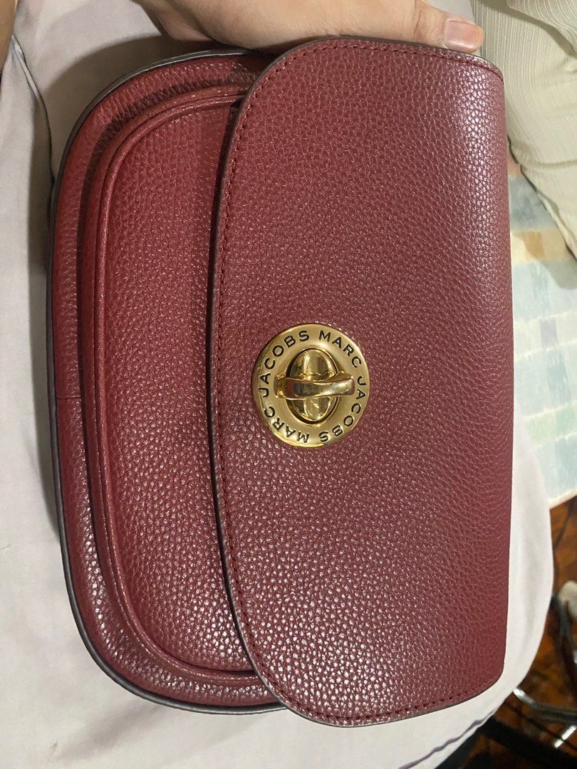 Marc Jacobs Signet Turnlock Saddle Bag (Category: Luxury Bags & Wallets) located in Cainta. Submitted by ahyish (Listing ID 1406232410, Image 2). Description: - Authentic Marc Jacobs Saddle bag - Burgundy leather exterior - Gold-tone logo clasp - Detachable striped strap with Marc Jacobs logo (some marks present) - Burgundy interior - Interior pocket - Comes with original tags.