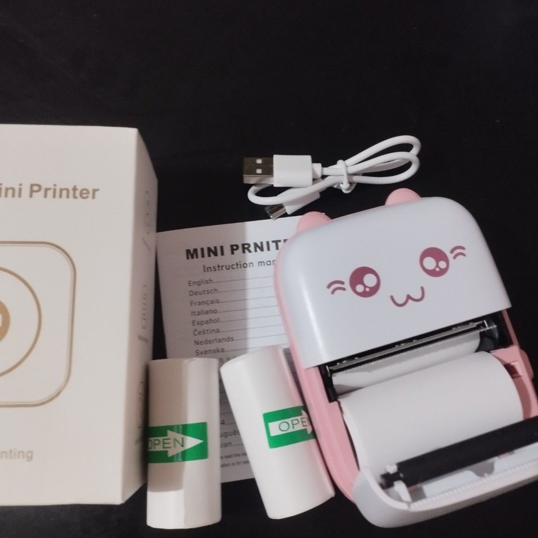 Mini Portable Wireless Bluetooth Thermal Photo Pocket Printer (Category: Printers, Scanners & Copiers) located in Tarlac. Submitted by zy.aniks (Listing ID 1406279660, Image 1). Description: What’s Included: ҂ Box ҂ (2) Sticker Papers + (1) Plain Paper ҂ Type-C Charging Cable ҂ Instruction Manual Perfect for: 📝 Notes, To-Do Lists, Receipts, & Waybill 📸 Photos & Creative Prints 🎨 Journaling, Scrapbooks, Labels, and More!.