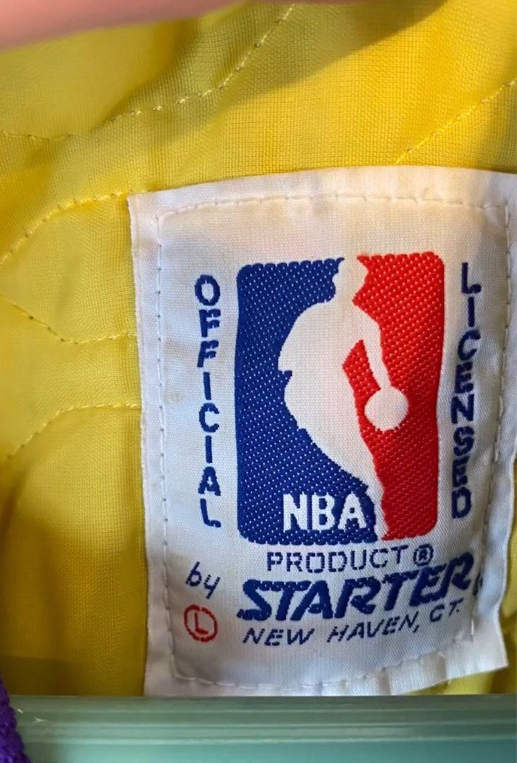 Starter NBA Los Angeles Lakers Jacket (Category: Coats, Jackets and Outerwear) located in Muntinlupa City. Submitted by sunsandandwaves (Listing ID 1406284274, Image 3). Description: NEGOTIABLE for sure buyer - Vintage Los Angeles Lakers jacket by Starter - Purple satin exterior - Yellow and white accents - Lakers logo on chest - NBA official licensed product - Quilted yellow lining - Purple ribbed collar, cuffs, and hem - Snap closures.