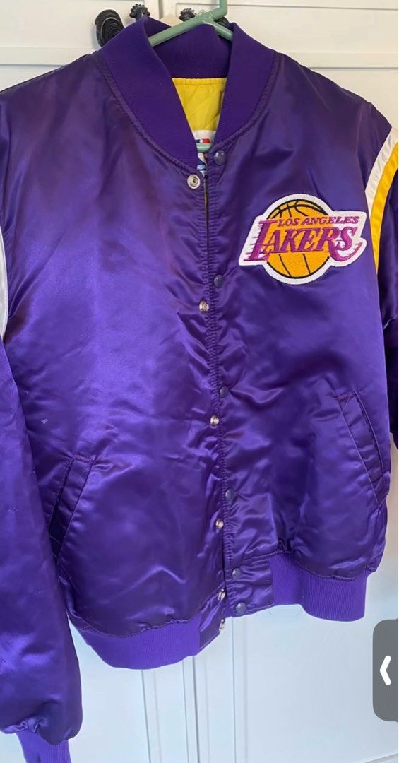 Starter NBA Los Angeles Lakers Jacket (Category: Coats, Jackets and Outerwear) located in Muntinlupa City. Submitted by sunsandandwaves (Listing ID 1406284274, Image 1). Description: NEGOTIABLE for sure buyer - Vintage Los Angeles Lakers jacket by Starter - Purple satin exterior - Yellow and white accents - Lakers logo on chest - NBA official licensed product - Quilted yellow lining - Purple ribbed collar, cuffs, and hem - Snap closures.