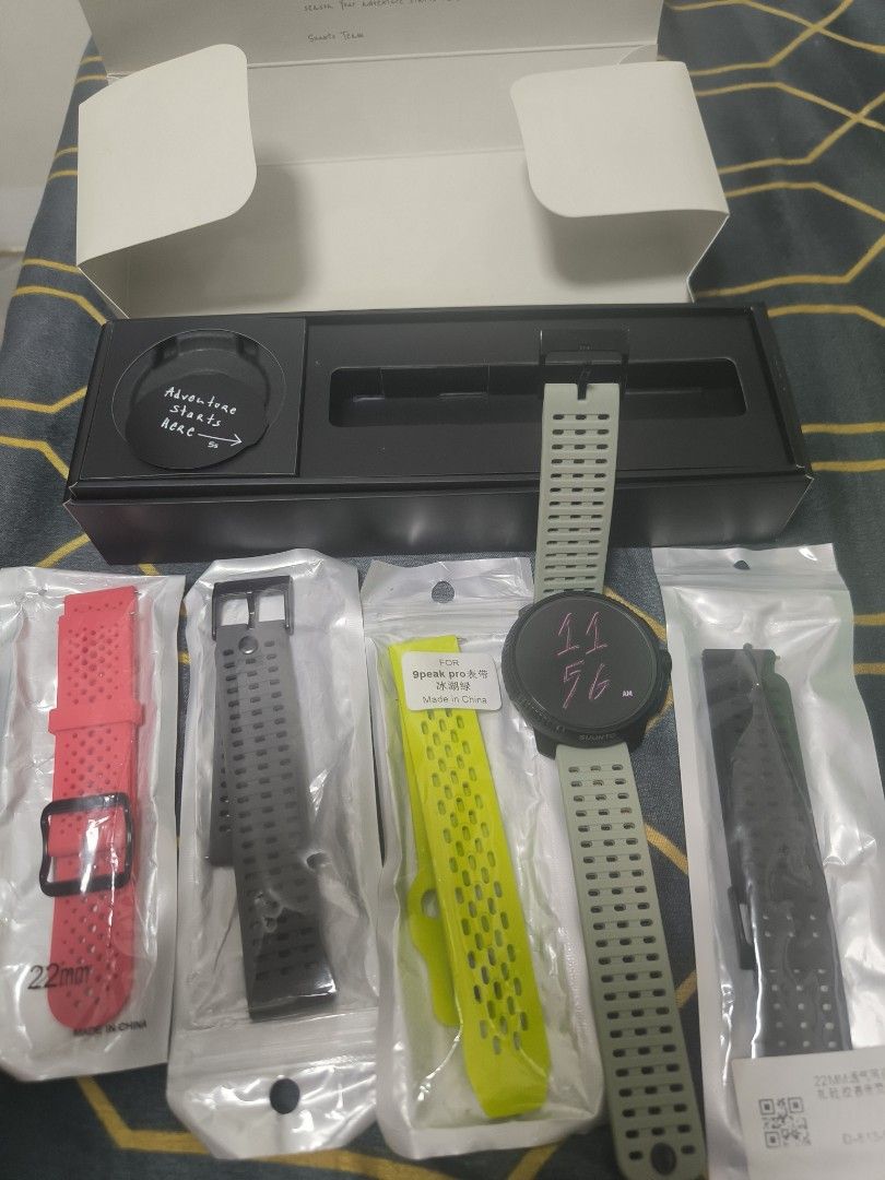 Suunto Race All Black Smartwatch (Category: Men's Watches) located in Cavite. Submitted by bowthrustalexey (Listing ID 1406128963, Image 2). Description: Suunto Race All Black smartwatch with multiple straps. Includes the original box, charging cable, and additional straps in red, black, and yellow. The watch features a round display and a black bezel. The box indicates the watch is designed in Finland and made in China. The watch has a green str