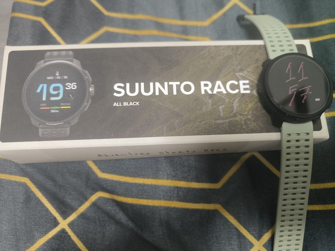 Suunto Race All Black Smartwatch (Category: Men's Watches) located in Cavite. Submitted by bowthrustalexey (Listing ID 1406128963, Image 1). Description: Suunto Race All Black smartwatch with multiple straps. Includes the original box, charging cable, and additional straps in red, black, and yellow. The watch features a round display and a black bezel. The box indicates the watch is designed in Finland and made in China. The watch has a green str