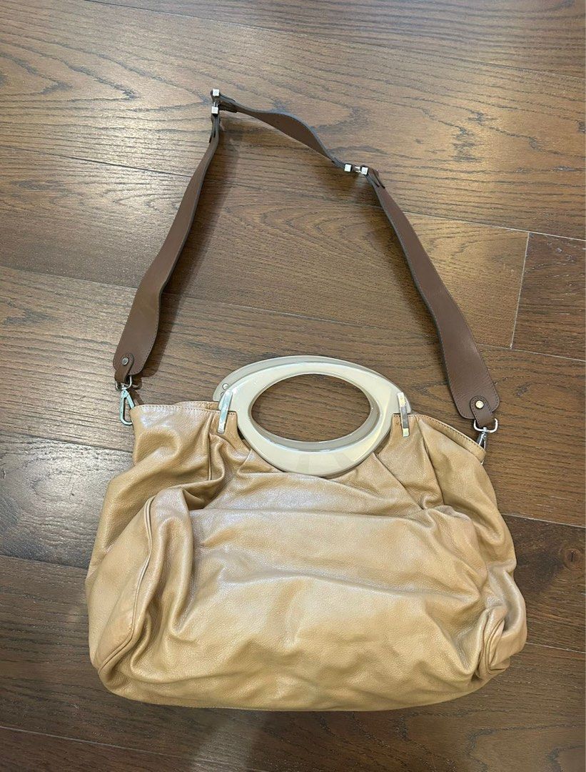 Marni Tan Leather Handbag with Shoulder Strap (Category: Shoulder Bags) located in Makati City. Submitted by sharingtree (Listing ID 1406242583, Image 1). Description: Tan leather handbag with oval handle and detachable shoulder strap. Silver hardware. Spacious and slouchy design. Great for everyday use..