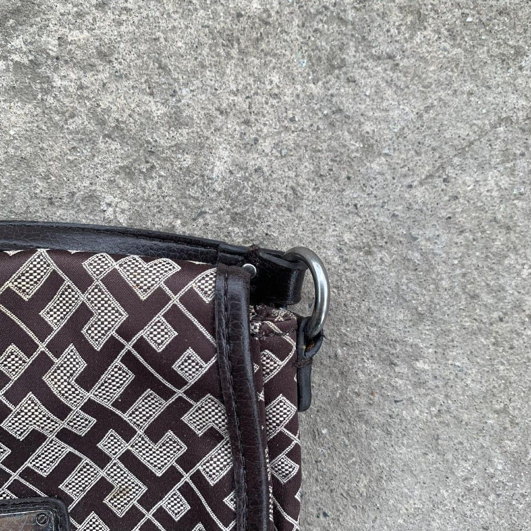 Tommy Hilfiger Crossbody Bag (Category: Cross-body Bags) located in Manila. Submitted by emmanthrift (Listing ID 1406276756, Image 3). Description: Features a brown and beige pattern, flap closure, and adjustable strap. Lined with blue fabric..