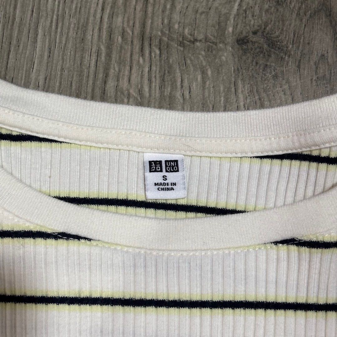 Uniqlo Striped Ruffle Ribbed Top (S) (Category: Shirts) located in Valenzuela. Submitted by choppersells (Listing ID 1406204681, Image 3). Description: 🖤 Uniqlo Striped Ruffle Ribbed Top (S) Features a white ribbed fabric with horizontal black and subtle neon yellow stripes. It has a crew neck, short sleeves, and cute lettuce-edge ruffle trim on the sleeves and hemline. 📏 Size: Small 🛍️ Bought in Hong Kong ✨ Condition: Excellent condition. 🚚 