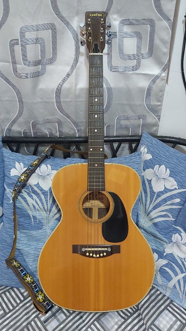 Vintage Acoustic Guitar with Case (Category: Musical Instruments) located in Quezon City. Submitted by benjamu1950 (Listing ID 1406110793, Image 2). Description: -Kasuga Classic acoustic guitar - Natural wood finish - Black pickguard - Includes guitar strap - Comes with a blue, padded protective case - Traditional design with six strings *Text/call: 09947179307.