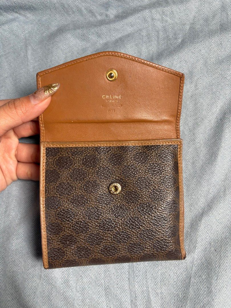Aunthentic Celine Tri-Fold Wallet (Category: Luxury Bags & Wallets) located in Manila. Submitted by tatisdeclutters (Listing ID 1406303976, Image 3). Description: - Authentic Celine tri-fold wallet - Features the iconic Celine logo - Multiple card slots and coin compartment - Brown leather exterior with Celine print - Brown leather interior - Compact size, ideal for everyday use.