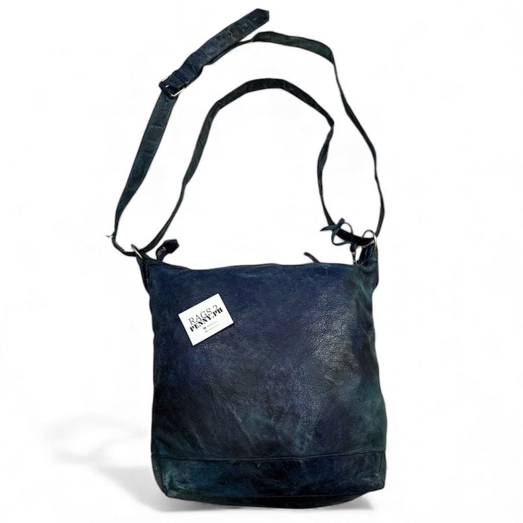 Balenciaga Leather Shoulder Bag (Category: Luxury Bags & Wallets) located in Kabacan. Submitted by rags2penny.phl (Listing ID 1406303739, Image 2). Description: -Authentic Balenciaga shoulder bag in a distressed leather finish. -Features multiple zippered compartments and a long adjustable strap. -The interior includes a leather tag with the brand name and "Made in Italy" printed. -The bag has a unique, textured appearance with silver-tone hardwa