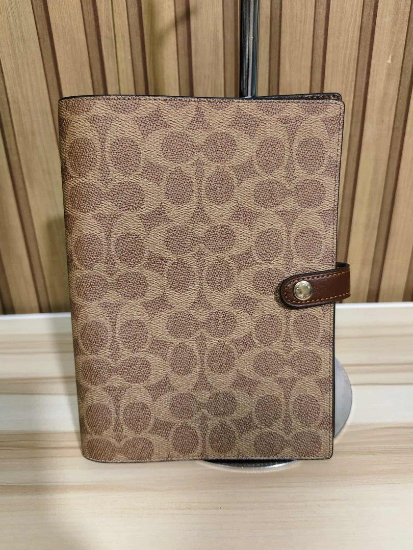 Coach Signature Organizer (Category: Accessory Holder, Box & Organizers) located in Manila. Submitted by oliviavaleria (Listing ID 1406380514, Image 1). Description: - Authentic Coach organizer - Signature Coach pattern exterior - Brown leather strap with snap closure - Light brown interior.