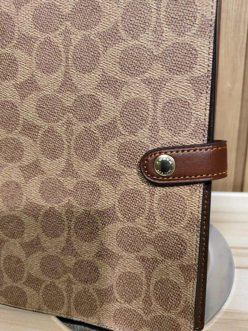 Coach Signature Organizer (Category: Accessory Holder, Box & Organizers) located in Manila. Submitted by oliviavaleria (Listing ID 1406380514, Image 2). Description: - Authentic Coach organizer - Signature Coach pattern exterior - Brown leather strap with snap closure - Light brown interior.