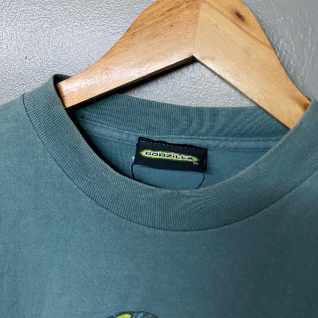 Godzilla Movie T-Shirt (Category: Tshirts & Polo Shirts ) located in Cagayan de Oro. Submitted by sumamestreethub (Listing ID 1406423601, Image 3). Description: - Vintage Godzilla t-shirt - From 1998 - Features Godzilla logo and monster design - Graphic on front and back - Teal fabric - Perfect for Godzilla fans! W18.5 L25.