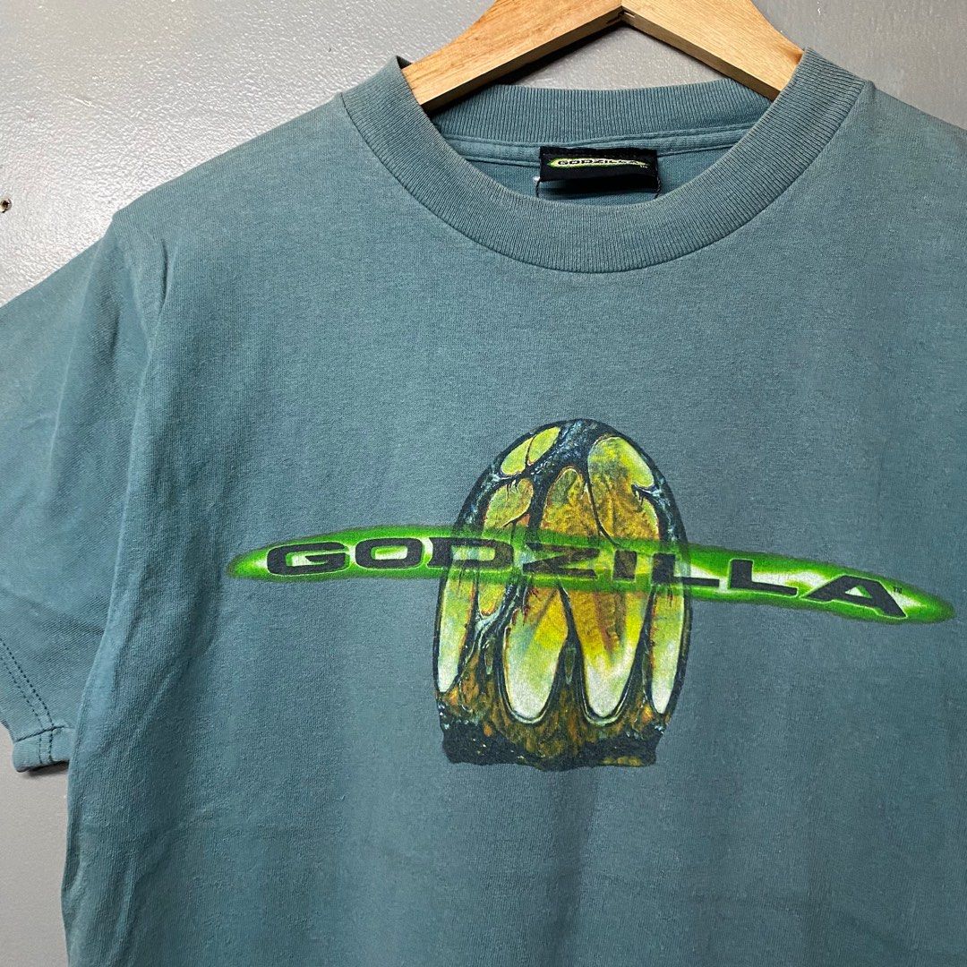 Godzilla Movie T-Shirt (Category: Tshirts & Polo Shirts ) located in Cagayan de Oro. Submitted by sumamestreethub (Listing ID 1406423601, Image 2). Description: - Vintage Godzilla t-shirt - From 1998 - Features Godzilla logo and monster design - Graphic on front and back - Teal fabric - Perfect for Godzilla fans! W18.5 L25.