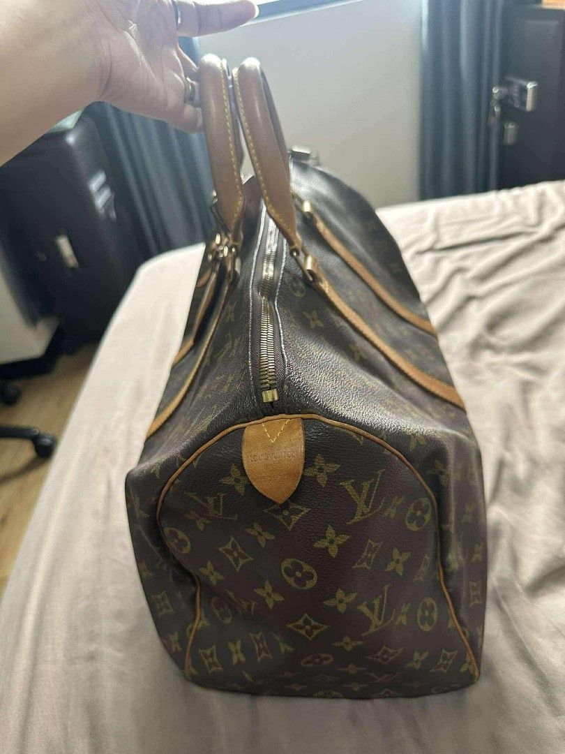 Louis Vuitton Keepall 55 Travel Bag (Category: Luxury Bags & Wallets) located in Manila. Submitted by blapez (Listing ID 1406424700, Image 2). Description: Authentic Louis Vuitton Keepall 55 travel bag. Features the iconic monogram canvas, leather handles, and a top zip closure. Includes a luggage tag and a padlock. The bag has a spacious interior, perfect for travel. Date code SP0047..