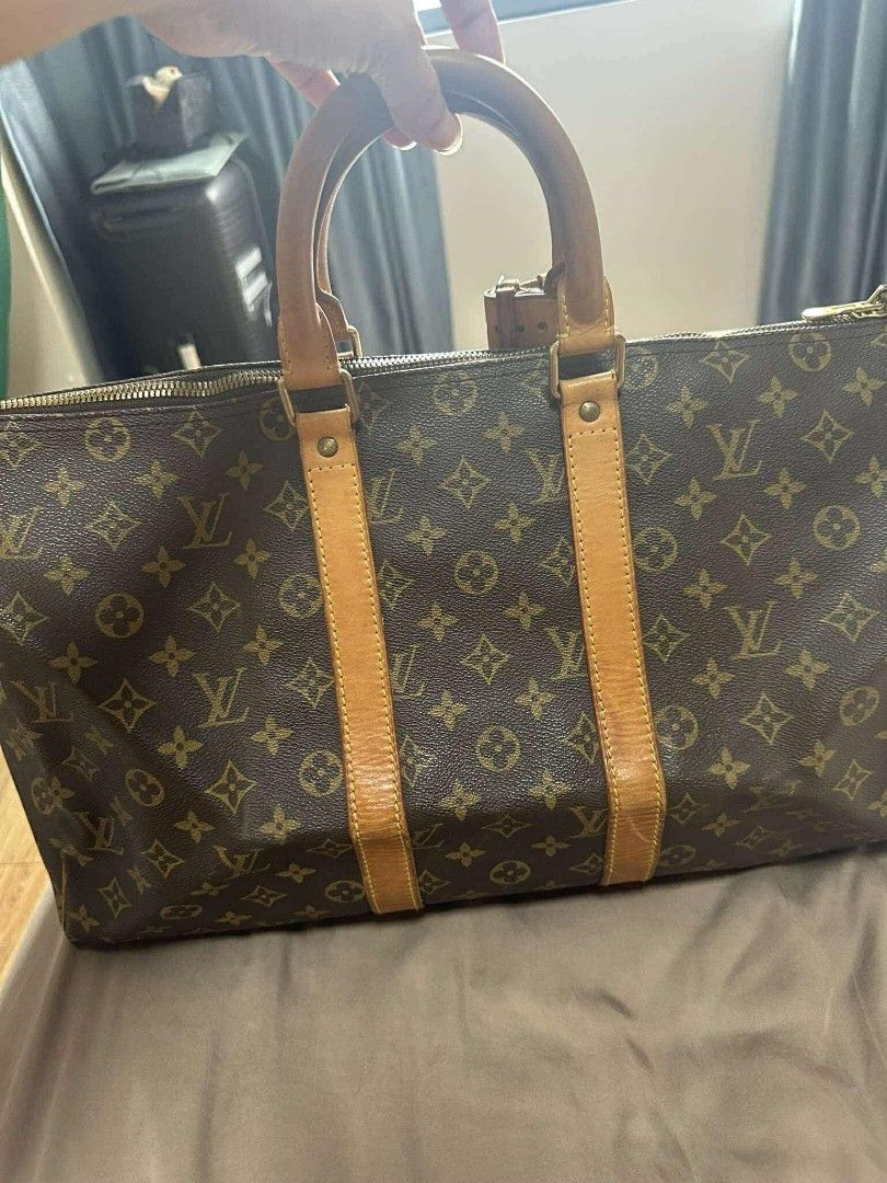 Louis Vuitton Keepall 55 Travel Bag (Category: Luxury Bags & Wallets) located in Manila. Submitted by blapez (Listing ID 1406424700, Image 3). Description: Authentic Louis Vuitton Keepall 55 travel bag. Features the iconic monogram canvas, leather handles, and a top zip closure. Includes a luggage tag and a padlock. The bag has a spacious interior, perfect for travel. Date code SP0047..