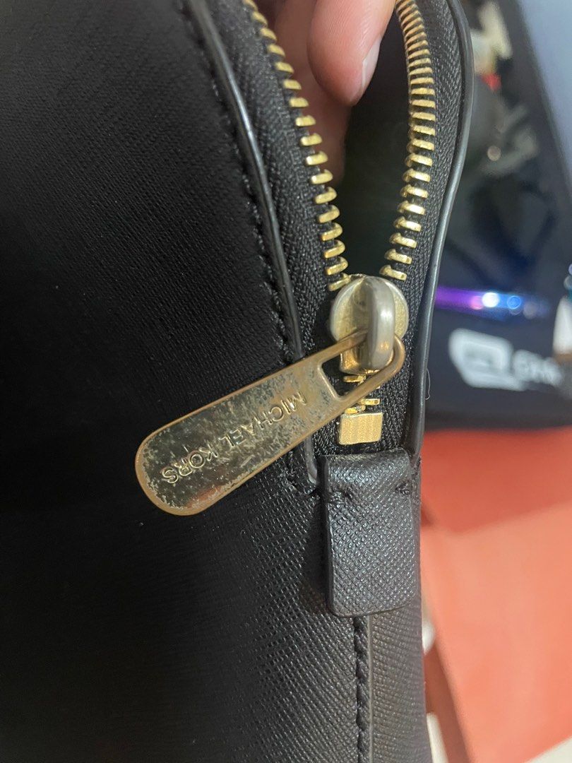 Michael Kors Dome Satchel Bag (Category: Luxury Bags & Wallets) located in Makati City. Submitted by sunsetk (Listing ID 1406300853, Image 3). Description: - Authentic Michael Kors dome satchel bag - Color: Black - Features: - Top handle with issue as shown in the pic - Detachable shoulder strap - Gold-tone hardware already tarnished as shown in the pic - Interior is still intact - Lined with Michael Kors logo fabric - Closure: Zipper with Michae