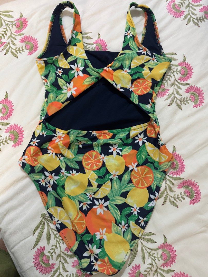Old Navy Fruit Print Swimsuit - Size S (Category: Bikinis & Swimsuits) located in Pasig City. Submitted by sud38405 (Listing ID 1406393788, Image 2). Description: Old Navy swimsuit features a vibrant fruit print. It has a navy blue lining and a cut-out back design. The size is Small (S). The fabric composition is 82% body, 18% spandex/elastane, and the lining is 100% polyester. Made in Vietnam. Not used, tag removed.